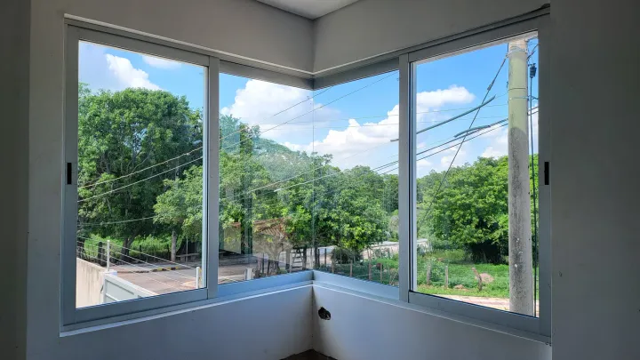 Ventana en esquina, de dos paños, con vista a los árboles